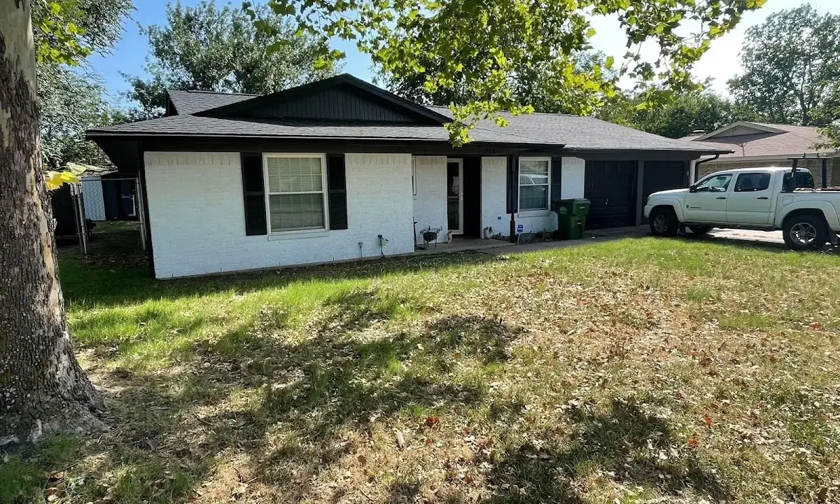 Professional roofing crew working on a residential roof in DeWitt